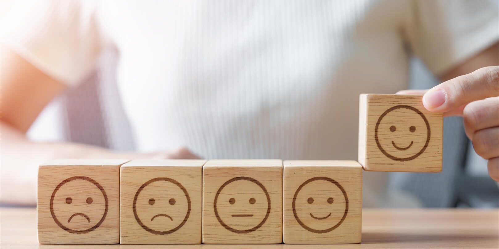 hand choosing smile face from emotion block 2025 03 06 16 02 51 utc