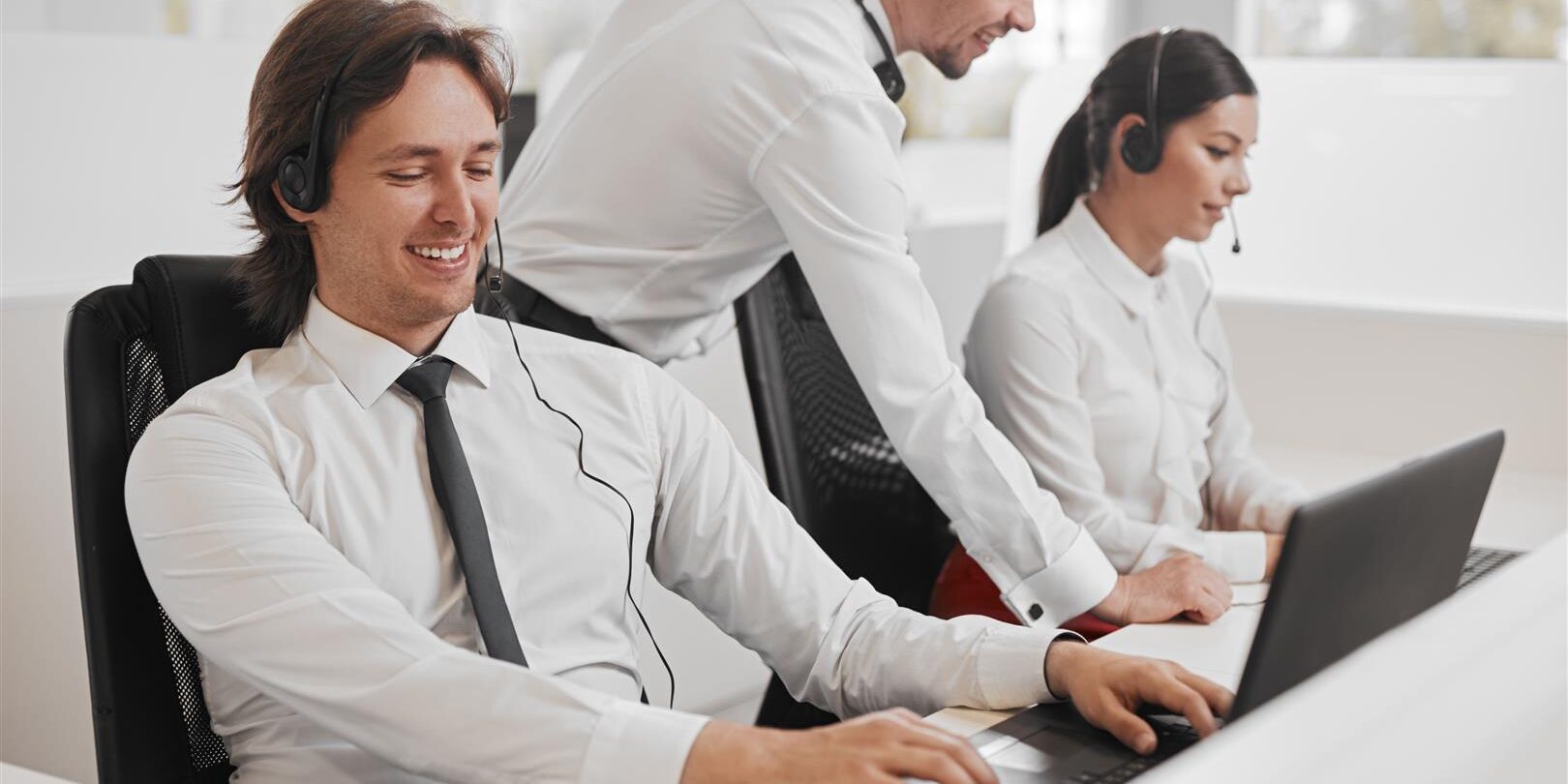 happy support agent using laptop near colleagues 2025 03 31 11 48 04 utc