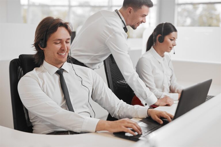 happy support agent using laptop near colleagues 2025 03 31 11 48 04 utc