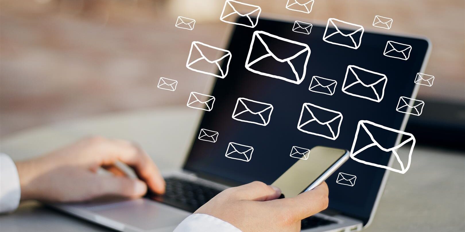 side view of hands using laptop and smartphone on 2026 01 11 08 47 10 utc