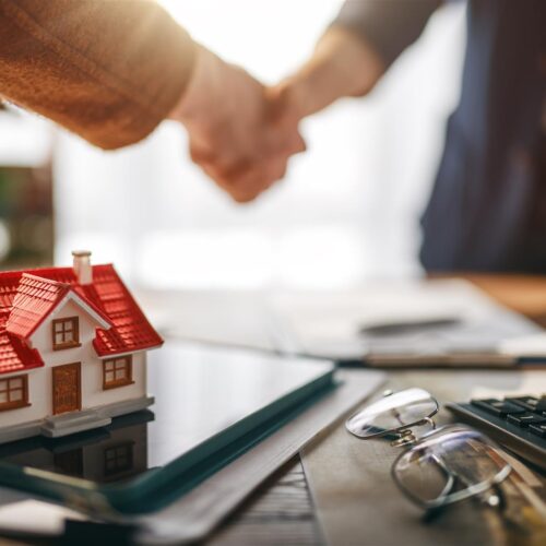 handshake close deal at table with model house 2026 06 16 06 26 36 utc